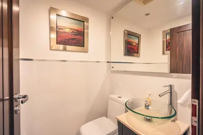 a bathroom with a toilet and a glass sink at Townhouse with ocean view Puerto Bahia in Los Grini