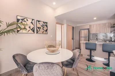 a dining room with a white table and chairs at Breakfast Included Fully Serviced Apartment at Regatta Living II - 204 in Santo Domingo