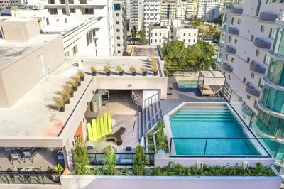 an aerial view of a building with a swimming pool at Breakfast Included Fully Serviced Apartment at Regatta Living II - 204 in Santo Domingo