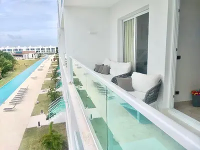 a balcony with a view of a swimming pool at Cana Rock De Lujo 344 Vista Al Campo De Golf in Punta Cana