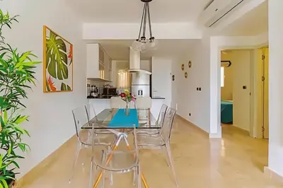 a dining room with a glass table and chairs at Cana Rock 108 Acceso Directo Piscina Punta Cana in Punta Cana