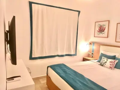 a bedroom with a bed with a window and a bed sidx sidx sidx at Cana Rock 351 Impresionante Vista A La Piscina in Punta Cana
