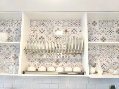 a cabinet filled with lots of white vases andtery at Cana Rock 351 Impresionante Vista A La Piscina in Punta Cana