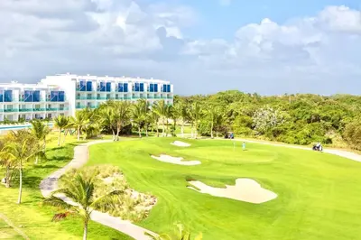 an aerial view of a golf course with a resort at Apartamento 120 Jardin Privado Cana Rock in Punta Cana