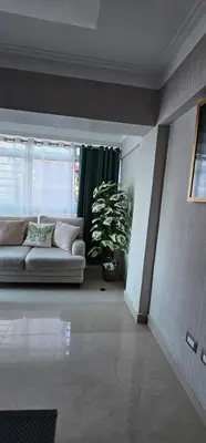 a living room with a couch and a plant at LEAN LUXURY Santo Domingo in Santo Domingo