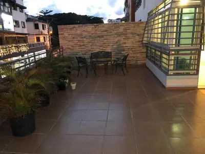 a patio with chairs and a table on a building at LEAN LUXURY Santo Domingo in Santo Domingo