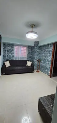 a living room with a black couch in a room at LEAN LUXURY Santo Domingo in Santo Domingo