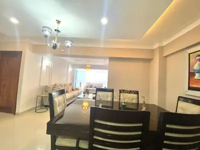 a dining room and living room with a table and chairs at LEAN LUXURY Santo Domingo in Santo Domingo
