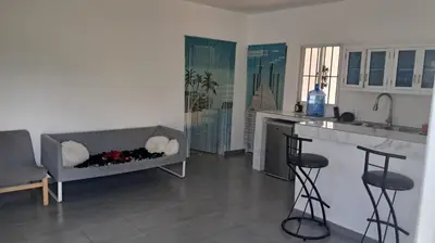 a living room with a couch and a kitchen at Casa A&A in Las Galeras
