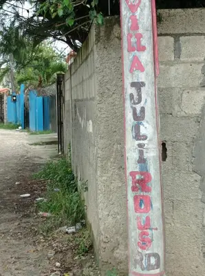 a sign on the side of a brick wall at Villa Julirous Rd-spa and ApartHotel, Camp for vacationers, 2 bedrooms in Boca Chica