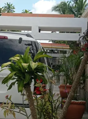 a white car parked next to a bunch of plants at Villa Julirous Rd-spa and ApartHotel, Camp for vacationers, 2 bedrooms in Boca Chica