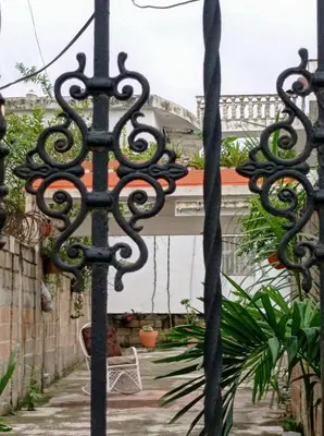 a pair of wrought iron gates in a garden at Villa Julirous Rd-spa and ApartHotel, Camp for vacationers, 2 bedrooms in Boca Chica