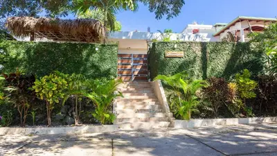 a house with a staircase with a green hedge at Villa Dylan Samana, Luxury 3Br with pool in Santa Bárbara de Samaná