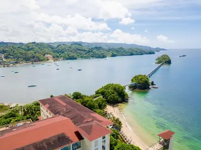 an island in the water with boats in it at Villa Dylan Samana, Luxury 3Br with pool in Santa Bárbara de Samaná