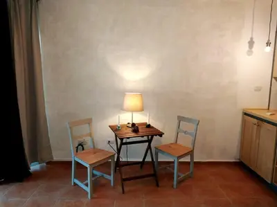 a table with two chairs and a lamp on it at Modern, Welcoming Studio, Ocean View in Juan Dolio in Juan Dolio