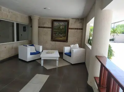 a living room with two chairs and a table at Modern, Welcoming Studio, Ocean View in Juan Dolio in Juan Dolio