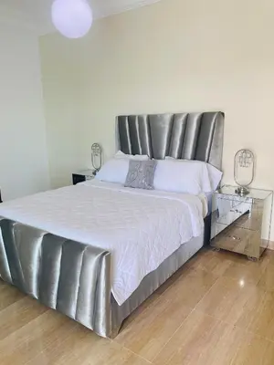 a large bed with a metal headboard in a bedroom at Malecón vista mar Habitación Privada Larimar, in Santo Domingo