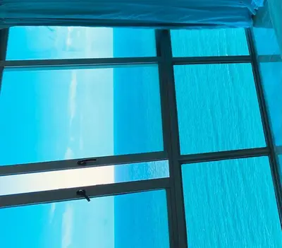 a view from the inside of a glass window at Malecón vista mar Habitación Privada Larimar, in Santo Domingo