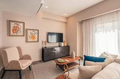 a living room with a couch and a tv at Apartment at Regatta Living II - 406 fully-equipped in Los Prados