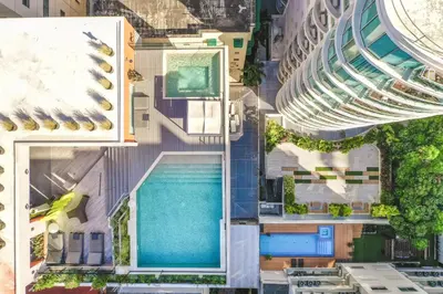 an overhead view of a building with a swimming pool at Apartment at Regatta Living II - 406 fully-equipped in Los Prados