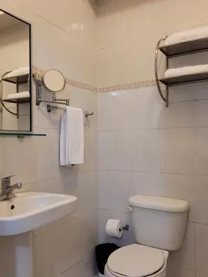 a bathroom with a toilet and a sink at Drake Bolivar Santo Domingo in Santo Domingo