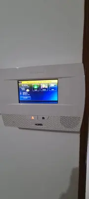 a white television sitting on top of a refrigerator at AMG Suites Apartment in Santo Domingo
