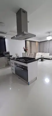 a kitchen with a stove top oven in a room at AMG Suites Apartment in Santo Domingo
