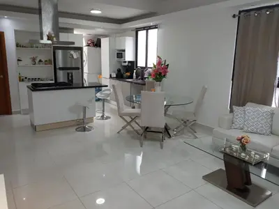a living room with a couch and a table at AMG Suites Apartment in Santo Domingo