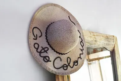 a hat hanging on a wall next to a window at Hostel Gato Colonial in Santo Domingo