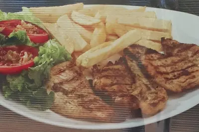 a plate of food with meat and french fries and a salad at CASITA HOGAREÑA JARABACOA (independent entrance) in Jarabacoa