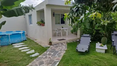 a backyard with a pool and a table and chairs at Casa taina in Jarabacoa