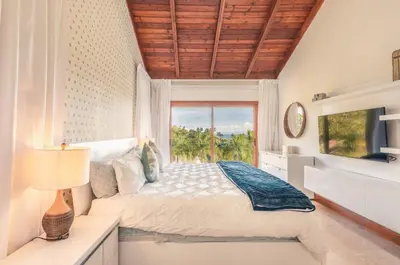 a bedroom with a bed and a window at Villa with 3 bedrooms private pool and ocean view in Santa Bárbara de Samaná