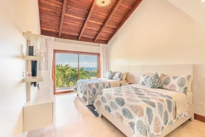 a bedroom with two beds and a window at Villa with 3 bedrooms private pool and ocean view in Santa Bárbara de Samaná