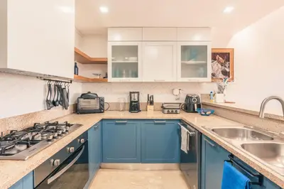 a kitchen with blue cabinets and a sink at Villa with 3 bedrooms private pool and ocean view in Santa Bárbara de Samaná
