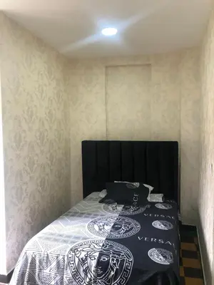 a bedroom with a bed with a black head board at Habitación Independiente Zona Colonial in Santo Domingo