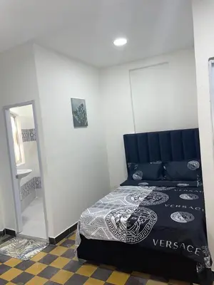 a bedroom with a bed with a black and white comforter at Habitación Independiente Zona Colonial in Santo Domingo