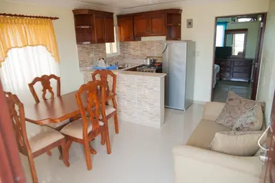 a kitchen and dining room with a table and chairs at Cozy Apartment Near Airport Wi-Fi & Parking in La Viva