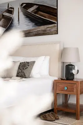 a bedroom with a bed and a picture of a boat at Cofresi Hills Residence in Gurapito