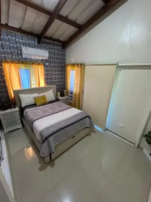 a bedroom with a bed in the middle of it at Villa La Grande in Jarabacoa
