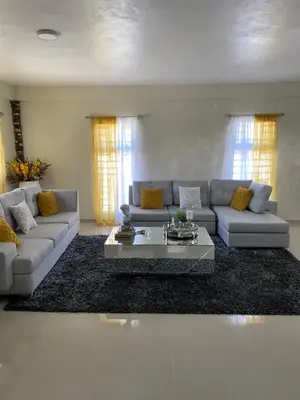 a living room with a couch and a coffee table at Villa La Grande in Jarabacoa