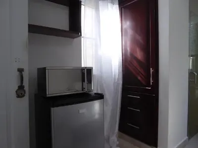 a tv sitting on top of a refrigerator in a room at Cozy Studios-Private Entrance- HS Internet-AC-Hot Water-Backup Generator-near the Beach in San Felipe de Puerto Plata