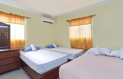a bedroom with two beds and a tv and windows at 1 Bedroom Apartment 1 Queen 2 Singles in La Viva