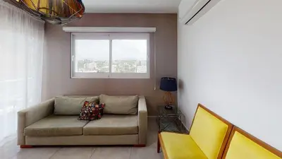 a living room with a couch and a window at Soha suites I in Santiago de los Caballeros