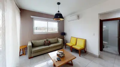 a living room with a couch and two chairs at Soha suites I in Santiago de los Caballeros