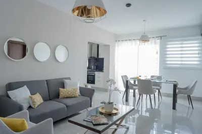 a living room with a couch and a table at Soha suites I in Santiago de los Caballeros