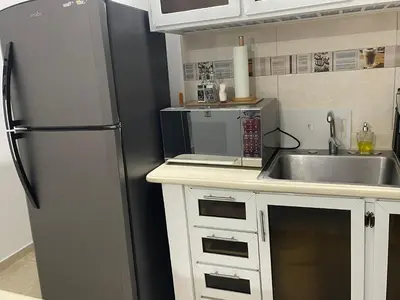 a kitchen with a refrigerator and a sink at Hospedaje de marant 1 in San Felipe de Puerto Plata