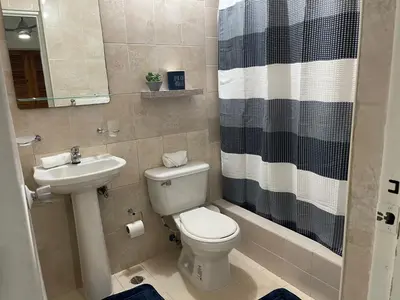 a bathroom with a toilet and a sink and a shower at Hospedaje de marant 1 in San Felipe de Puerto Plata