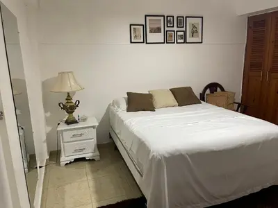 a bedroom with a bed and a lamp on a night stand at Hospedaje de marant 1 in San Felipe de Puerto Plata