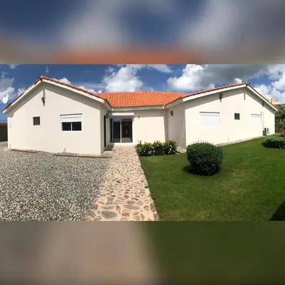 a white house with a driveway in front of it at Beautiful Villa in Boca Chica in Boca Chica