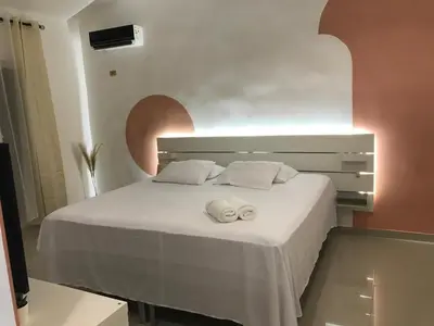 a white bed with two towels on top of it at Beautiful Villa in Boca Chica in Boca Chica